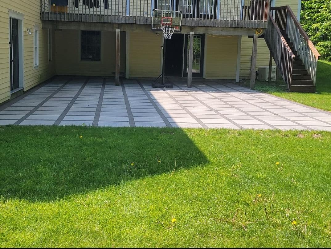 Paver patio with contrasting banding beneath an elevated deck